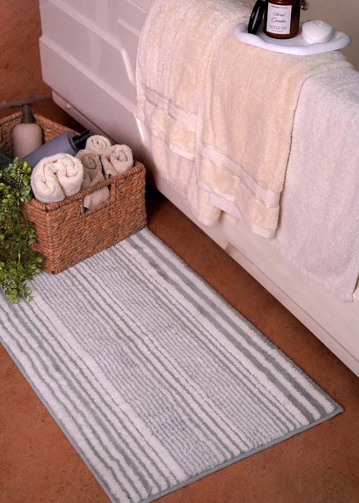 Rectangular bath mat with light gray vertical stripe pattern, plush textured surface