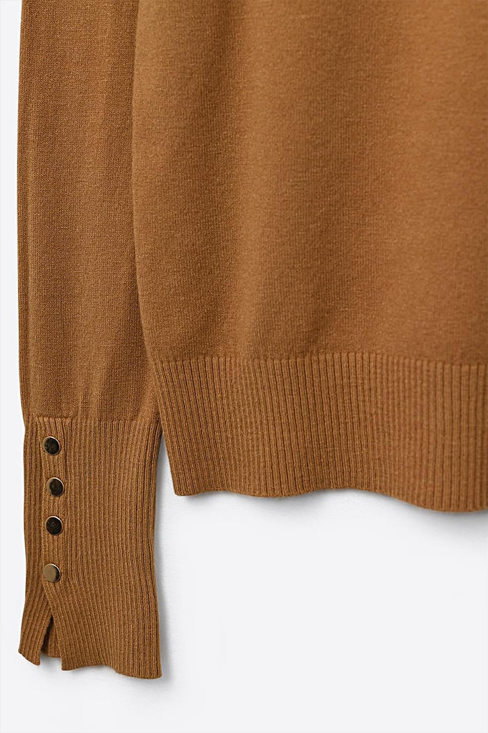 Camel turtleneck sweater with gold buttons on the cuff