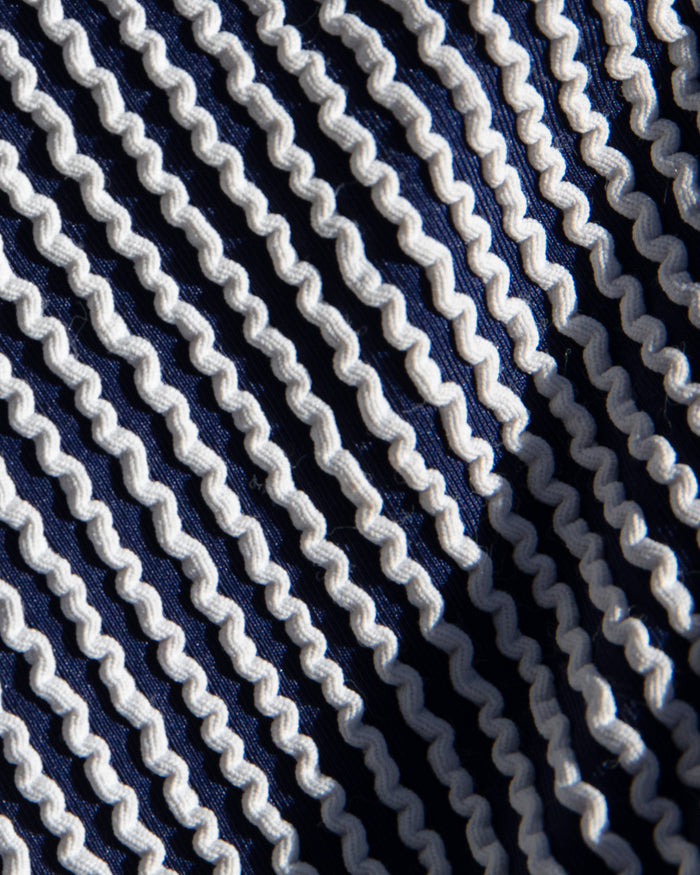 Close-up of midnight blue and white vertical stripe textured fabric used in the LSPACE midnight blue Coco One Piece Swimsuit.