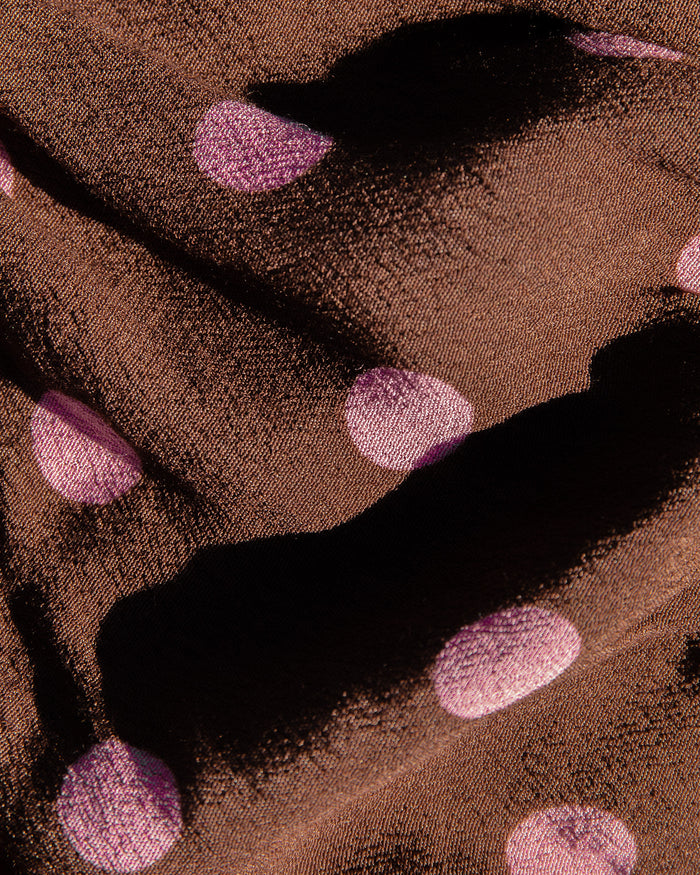 Close-up of the LSPACE Eyes On You Maxi in Alotta Polka Dot fabric, showing the brown base with large pink polka dot print detail.