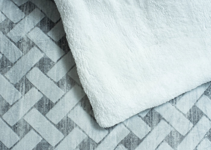 Soft quilted bedding set fabric with light textured chevron and plush top layer