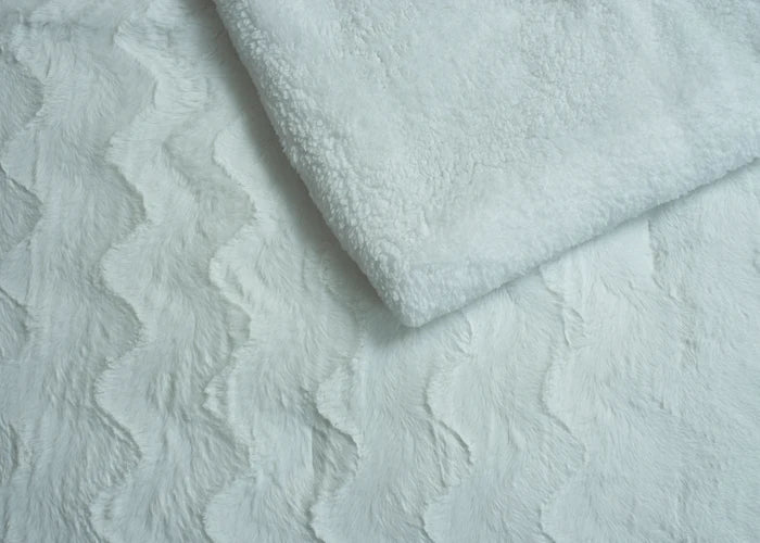 Ivory plush bedding fabric close-up with soft raised texture