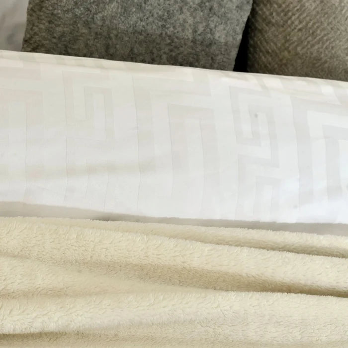 White duvet cover with subtle geometric pattern, smooth fabric close-up