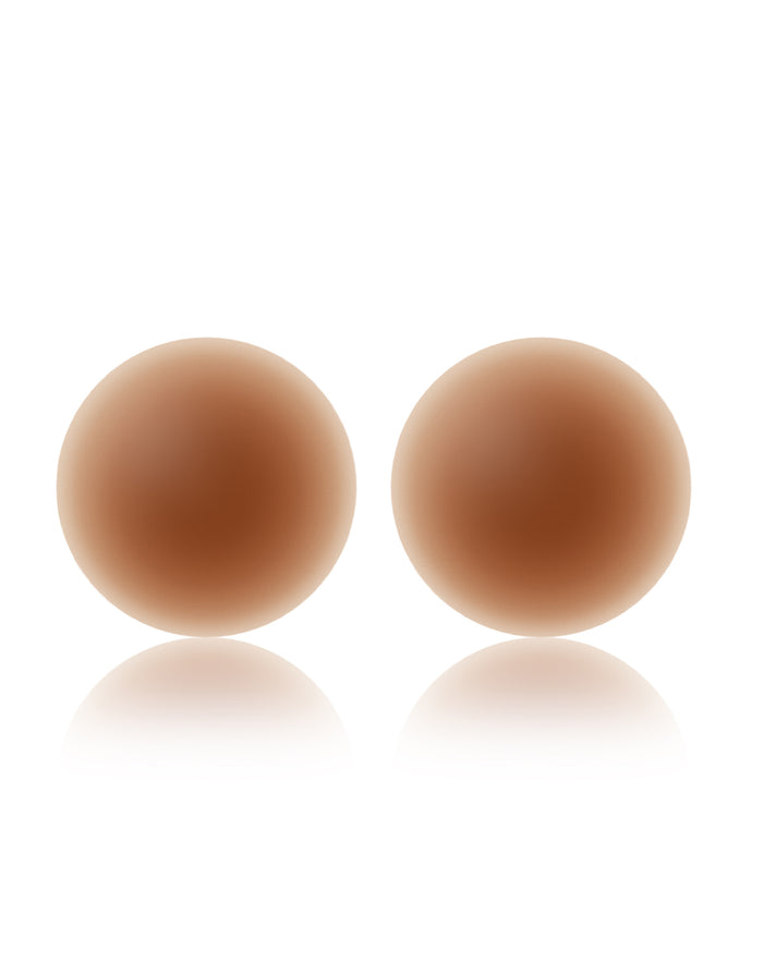 Off-model image of two round NOOD No Show Adhesive Nipple Covers in bronze on a white background.