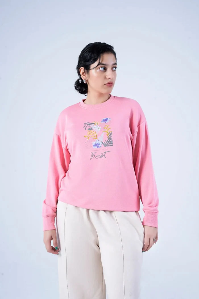 Women's pink crewneck knit sweatshirt with floral graphic front, long sleeves