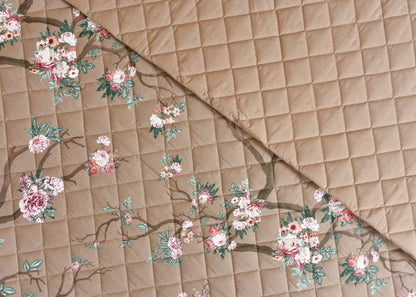 Coffee-brown quilted bedspread with floral bouquet print and stitched diamond pattern