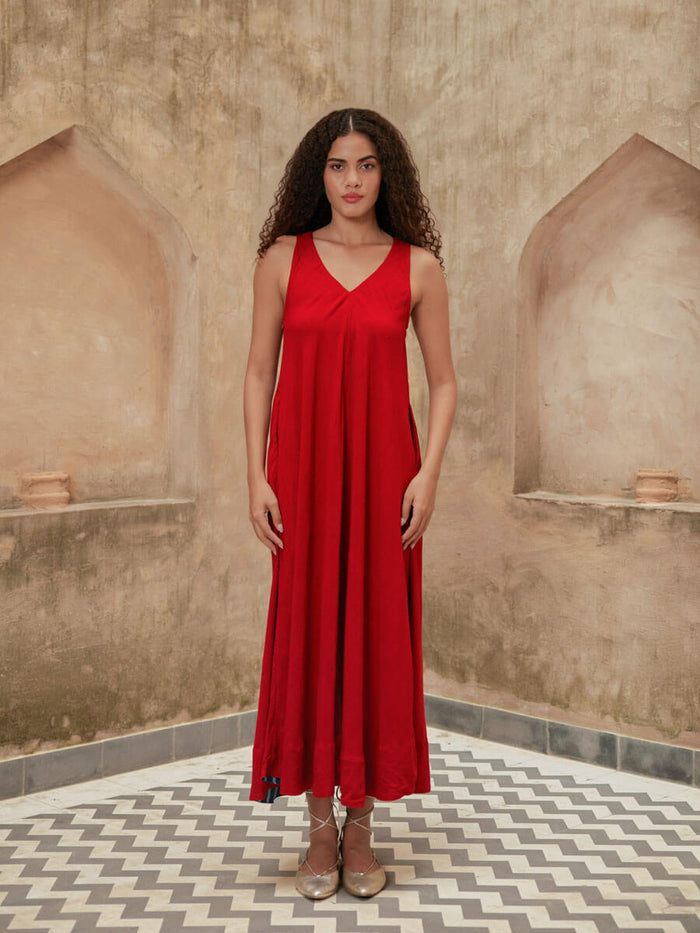 Woman wearing a red Pinklay sleeveless maxi dress.