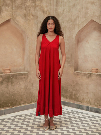 Woman wearing a red Pinklay sleeveless maxi dress.