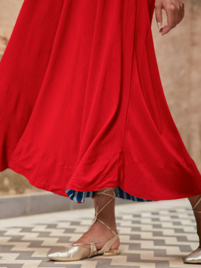 Woman wearing a red Pinklay sleeveless maxi dress.