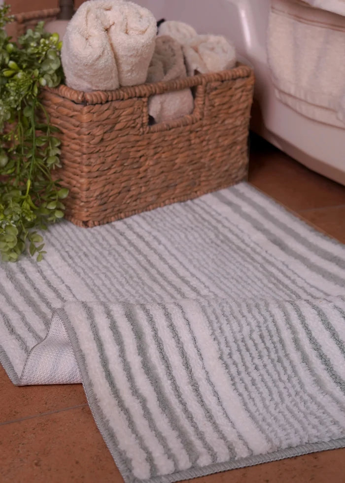 Rectangular bath mat with light gray vertical stripes, soft plush pile