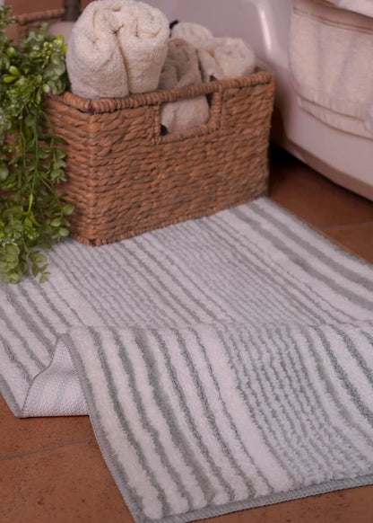Rectangular bath mat with light gray vertical stripes, soft plush pile
