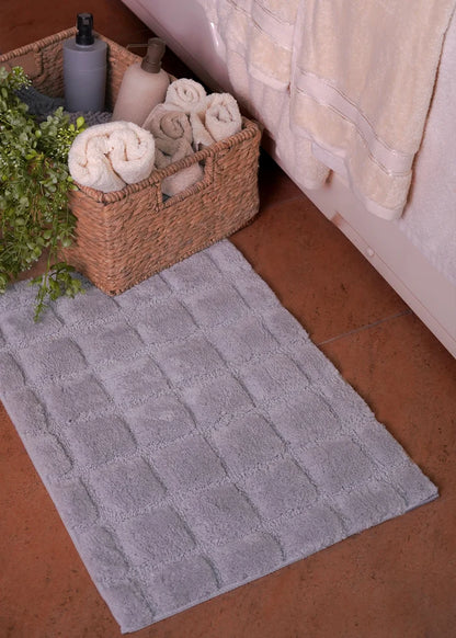 Grey polyester bath mat, rectangular with raised textured pattern
