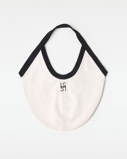 Off-model back view of the black and cream Bronte Canvas Bag showing a L*SPACE logo.