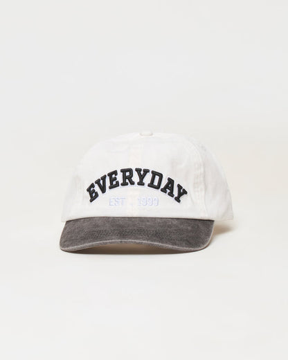 Everyday | Badge:New Arrival_#B2AC88_#ffffff'

A white baseball cap with a dark gray washed brim, featuring 'EVERYDAY EST. 1999' embroidered on the front in black and light blue.