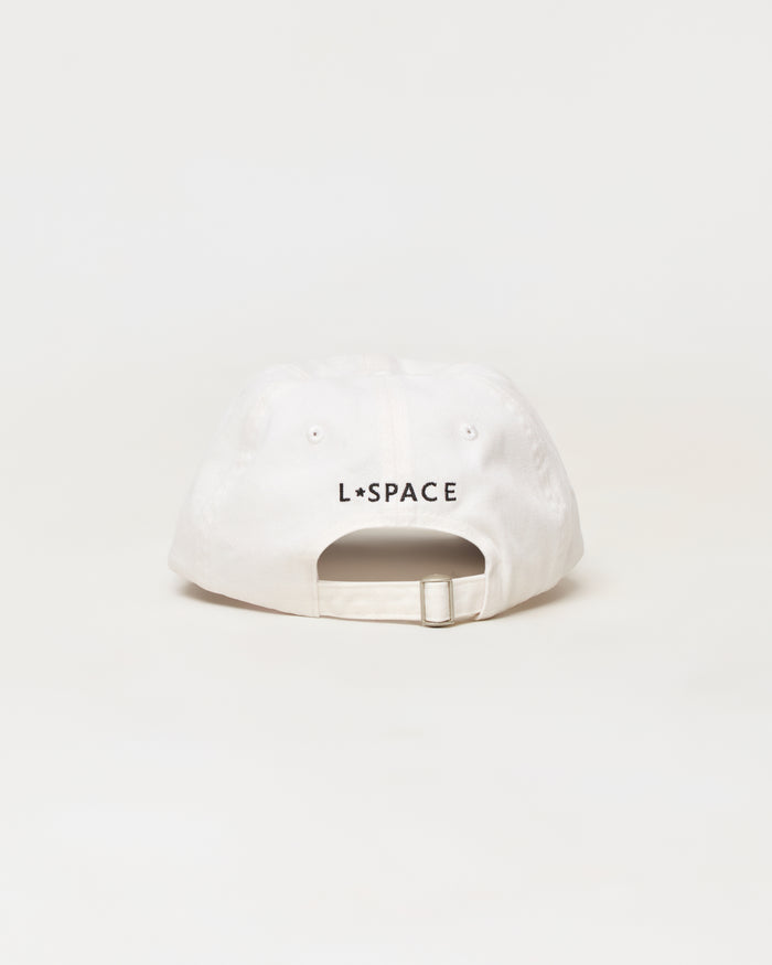 A white baseball cap shown from the back, featuring the black text 'L*SPACE' printed across the center. The cap has a curved brim, eyelets, and an adjustable snapback strap, photographed against a seamless white background.