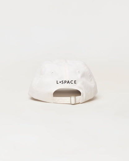 A white baseball cap shown from the back, featuring the black text 'L*SPACE' printed across the center. The cap has a curved brim, eyelets, and an adjustable snapback strap, photographed against a seamless white background.