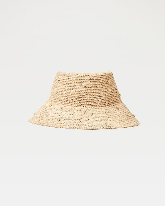 Off-model front view of the Carmel Island Hat in natural, a woven raffia bucket hat with scattered pearl embellishments, on a white background.