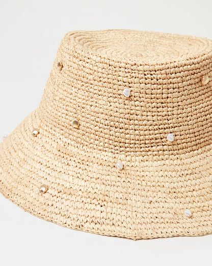 Close-up of the Carmel Island Hat in natural showing the woven raffia texture and scattered pearl and gold bead embellishments.