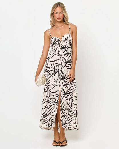 Front view of a model wearing the LSPACE Chara Maxi Dress in heavy petal, a black and white abstract floral print maxi dress with spaghetti straps and a front slit, on a white studio background.