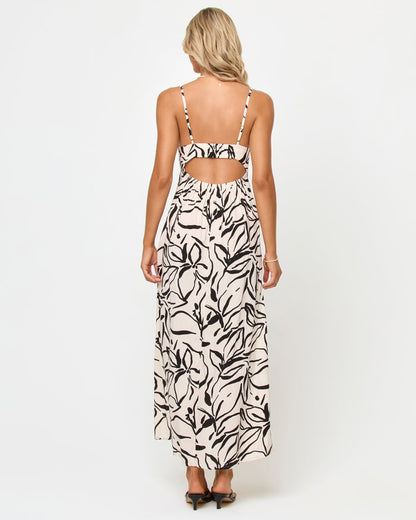 Back view of a model wearing the LSPACE Chara Maxi Dress in heavy petal, showing the open cut-out back panel and adjustable spaghetti straps, on a white studio background.