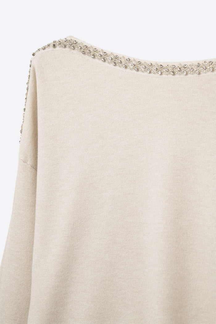 cream fine knit sweater with a boat neck and rhinestone detail