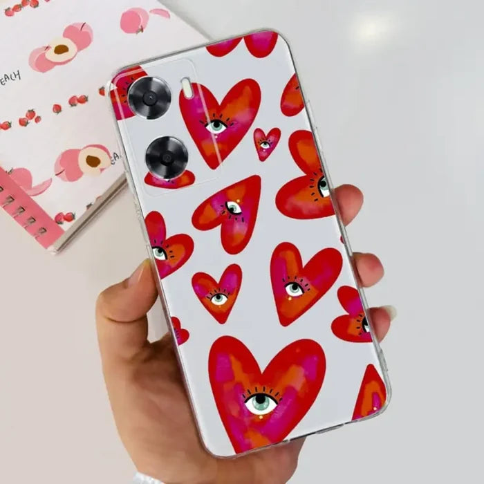 a hand holding a phone case with hearts on it