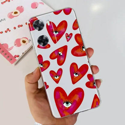 a hand holding a phone case with hearts on it