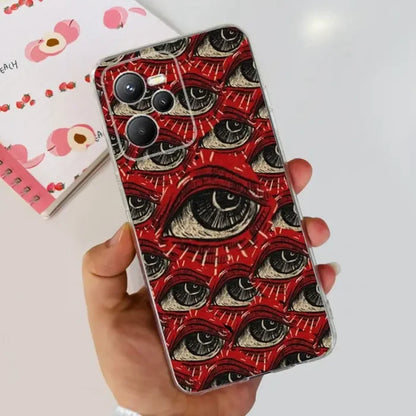 a hand holding a red phone case with an eye pattern