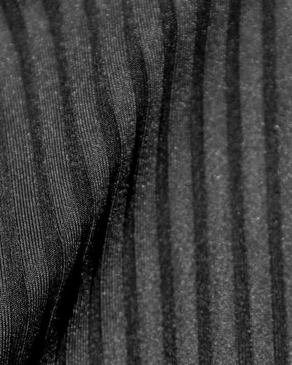 Close-up detail of the black ribbed eco-friendly fabric texture of the LSPACE Effie Bikini Top, off-model.