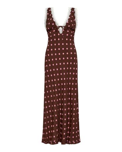 Off-model view of the LSPACE Eyes On You Maxi in Alotta Polka Dot, a full-length brown maxi dress with large pink polka dots, white lace trim V-neckline, and tie-front waist.