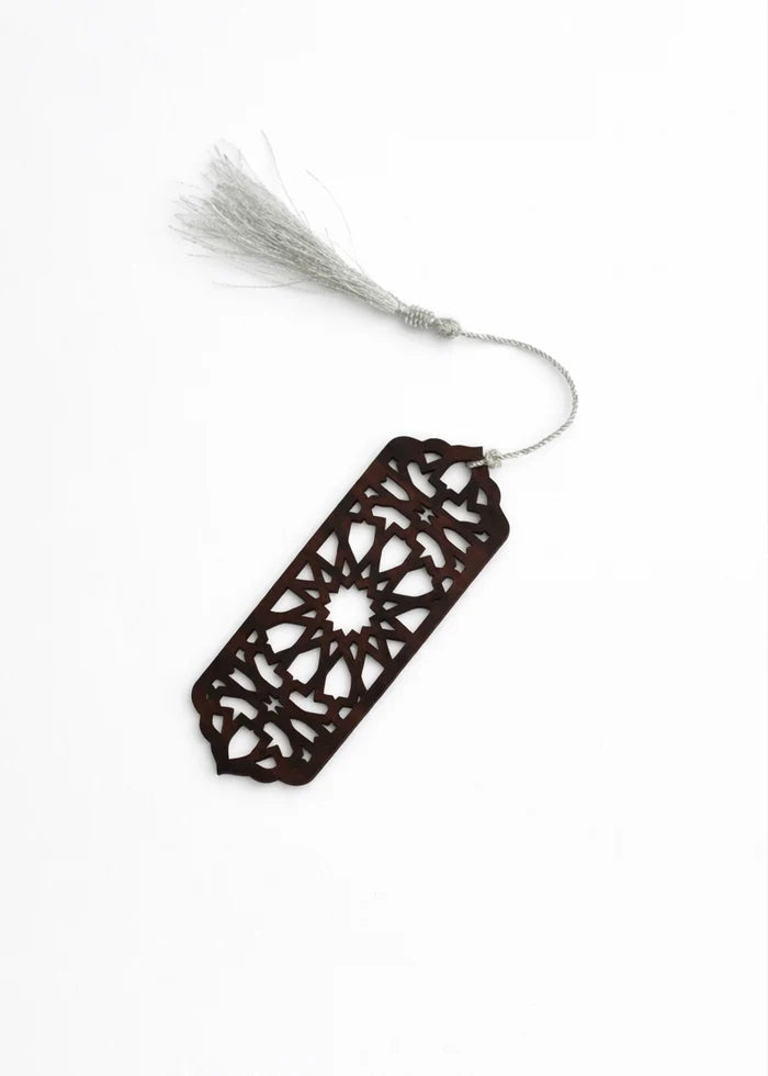 Decorative hanging ornament with dark cutout tag and white tassel cord