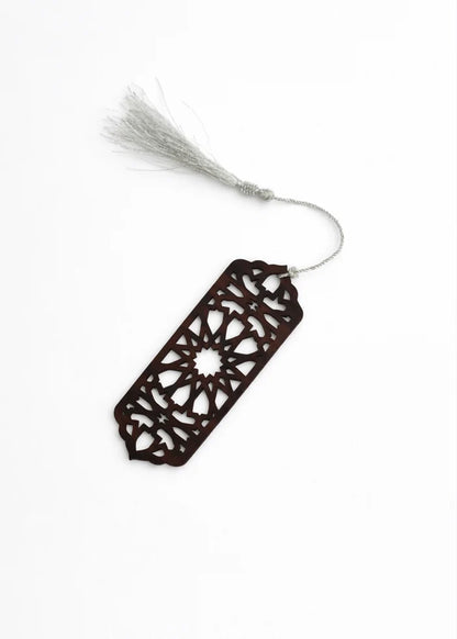 Decorative hanging ornament with dark cutout tag and white tassel cord