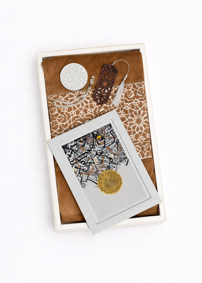 Gift set open box with gold medallion art, circular tag, and decorative cards