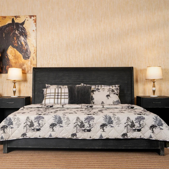 3-piece winter bed set on bed: tree-printed quilt with plaid and ribbed throw pillows