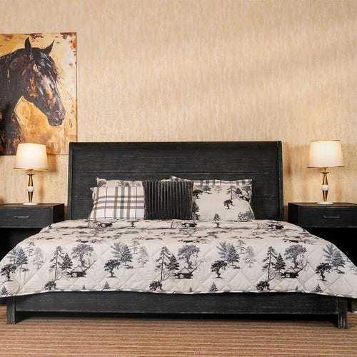 3-piece winter bed set on bed: tree-printed quilt with plaid and ribbed throw pillows
