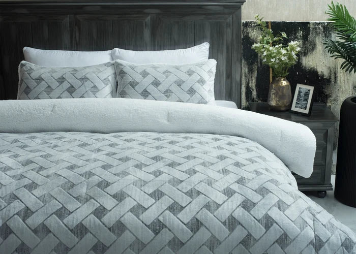 Quilted bedspread with light chevron stitch pattern and two matching decorative pillows