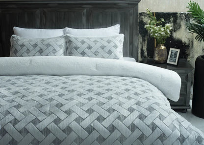 Quilted bedspread with light chevron stitch pattern and two matching decorative pillows