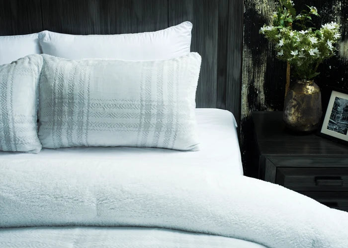 Light grey 3-piece bedding set featuring carved pillow shams and patterned duvet