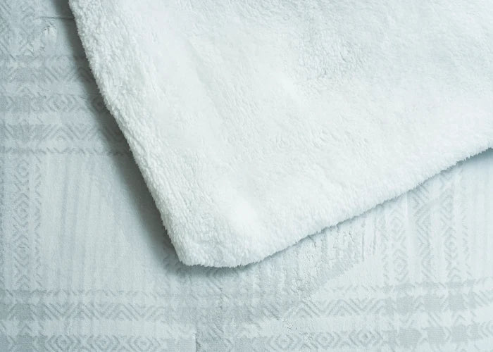 Light grey plush duvet top with carved geometric pattern and soft textured finish