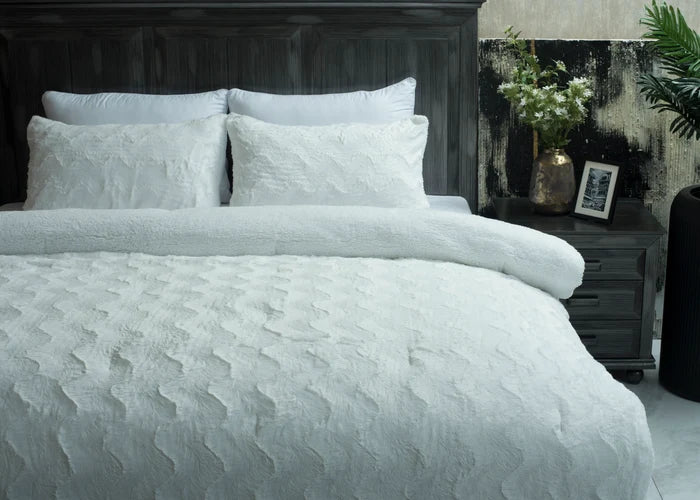 Ivory 3-piece plush winter bedding set on bed with duvet and pillows