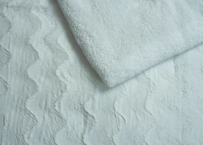 Ivory plush bedding fabric close-up with soft raised texture
