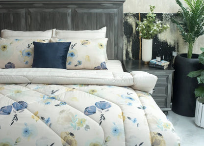 Cream floral comforter set with navy pillow covers on bed