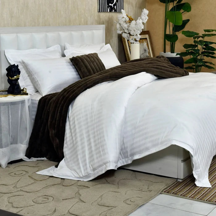 White duvet cover with dark brown ribbed blanket and matching pillows