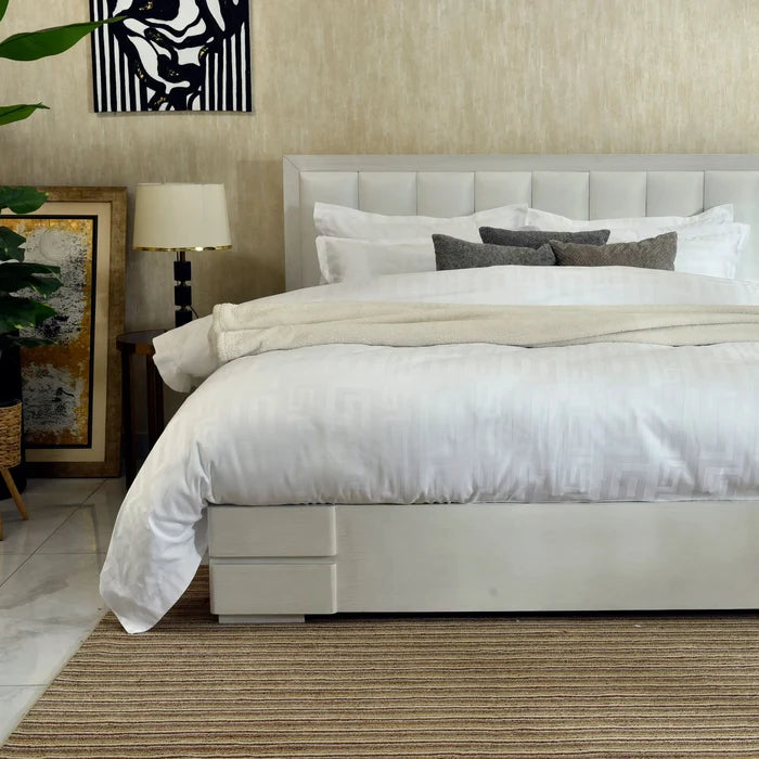 White duvet cover with matching pillow shams, smooth fabric, bed view