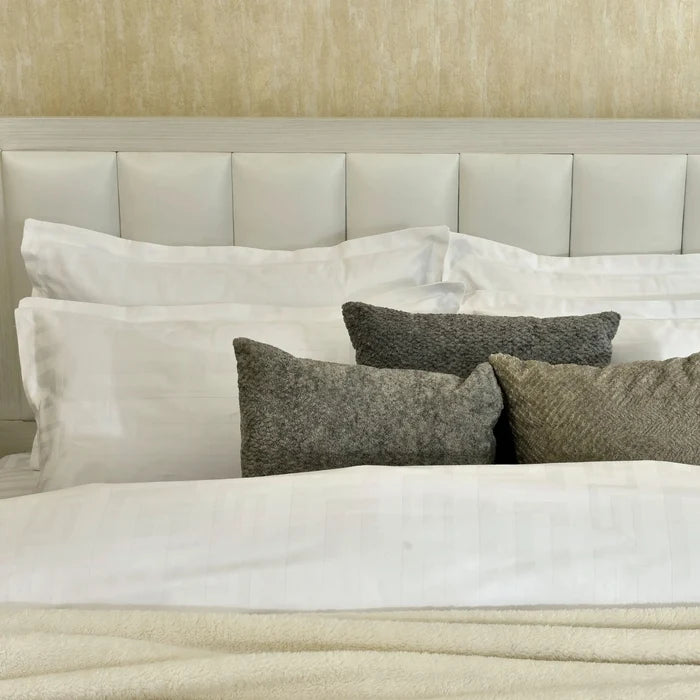 White duvet cover with gray accent pillows, bed-ready set