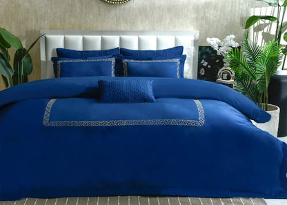 Cobalt blue duvet cover set with matching shams and patterned edge detail
