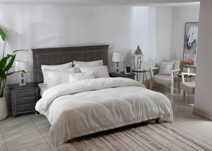 Off-white duvet cover and matching striped pillows on a bed