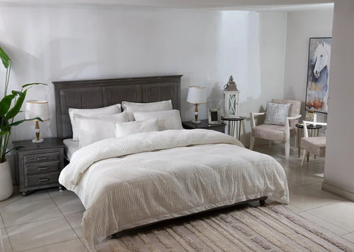 Off-white duvet cover and matching striped pillows on a bed