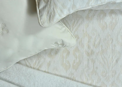 Beige jacquard duvet cover fabric with stitched edge and piping close-up