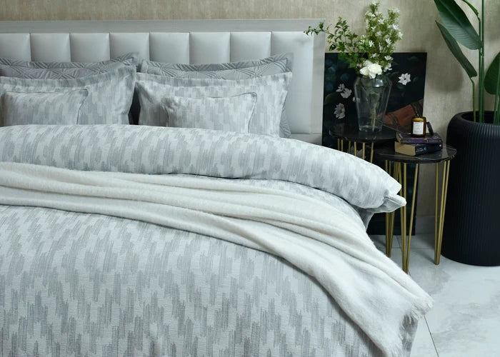 Grey patterned duvet cover set with layered pillow shams and stitched trim